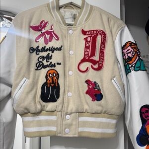 Sample Sale: Authorized Dealer Cream Varsity Jacket with Embroidered Patches.